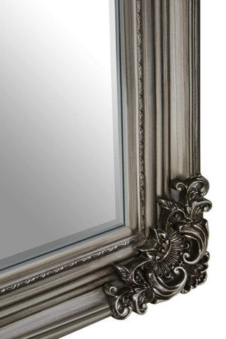 Decorative mirror with ornate frame on a white background