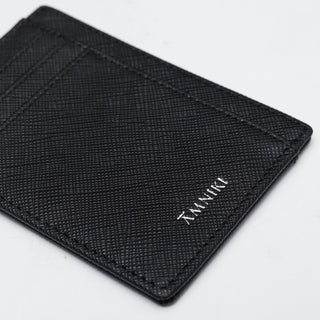 Black textured wallet with 'TIMBUK2' branding on a light gray background