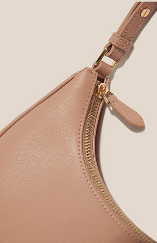 Beige bra with zipper and strap on a beige background