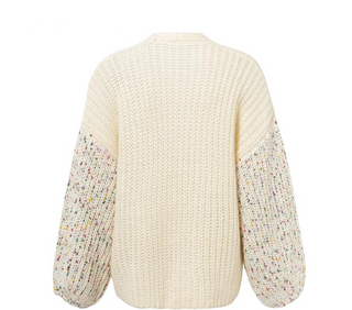Cream-colored knit sweater with multicolored sleeves on a white background