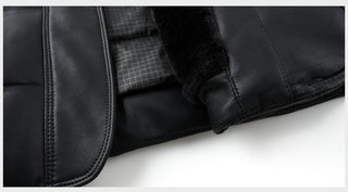 Close-up detail shot of a black leather jacket showing the smooth lapel stitching, a grid-patterned lining, and a black faux-fur collar on a white background.