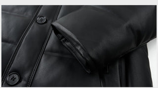 Close-up detail shot of a black faux-leather jacket sleeve with a raised padded cuff and dark buttons, shown against a light gray background with Chinese text at the bottom.