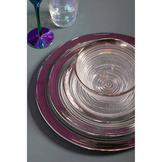 Set of glass plates with purple rim on a gray surface