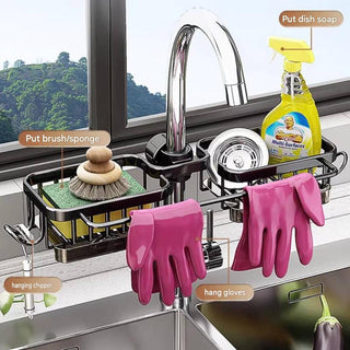 A wall-mounted double sink dish rack organizer shown installed over a kitchen sink. The black metal rack holds a sponge brush, a yellow Multi-Surface dish soap bottle, a metal strainer, and a pair of pink hanging gloves.