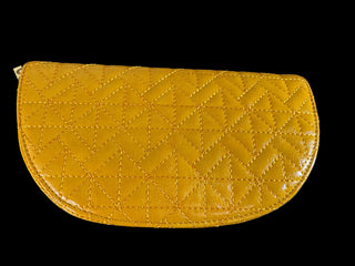 A yellow quilted leather pouch with a geometric stitched pattern, shown on a dark gray background.