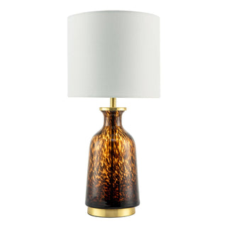 Table lamp with tortoiseshell-patterned base and white shade on a white background
