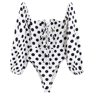 Black and white polka dot long-sleeve top on a white background